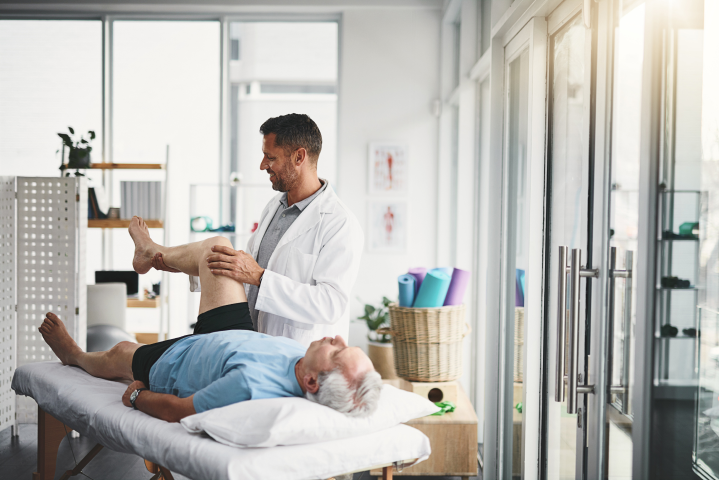 How Physiotherapists Can Improve Patient Outcomes with Targeted TENS Therapy physical-therapist-leg-pain-senior-patient-stretching-orthopedic-service-consulting-wellness-chiropractor-healthcare-man-with-client-rehabilitation-support-healing